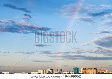 Rainbow In Evening Sky Over Residential District