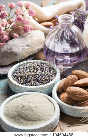 Nature cosmetics handmade preparation with essential oils and ancient minerals of perfume skincare creams soaps from fresh and dried lavender flowers roses wheat almond nuts green clay powder in French artisanal boutique home style