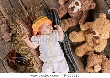 Sleeping baby and teddybears. Little kid on hay. The tight sleep.