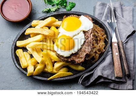 Peruvian Latin American food. Lomo a lo pobre. Beef whit fried potatoes french fry and eggs