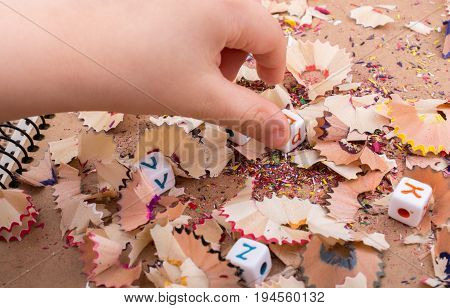 Colorful alphabet letter cubes in handon a canvas background