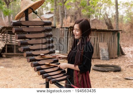 The lifestyle of rural girl playing Pong lang at countryside.