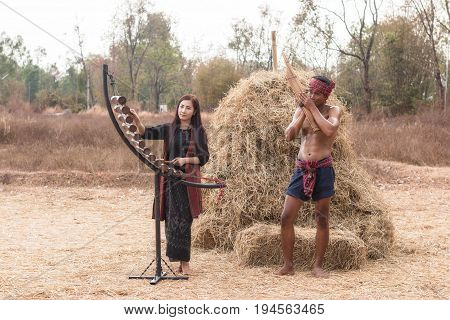 Asian beautiful girl are happy playing Pong Lang is a Thai musical instrument in summer at Countryside.