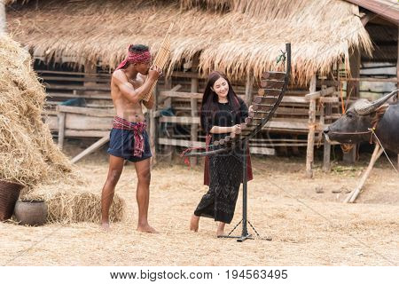 Asian beautiful girl are happy playing Pong Lang is a Thai musical instrument in summer at Countryside.