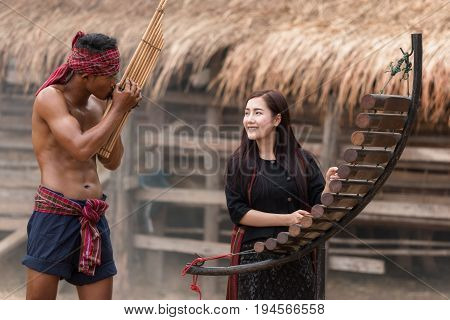 Asian beautiful girl are happy playing Pong Lang is a Thai musical instrument in summer at Countryside.