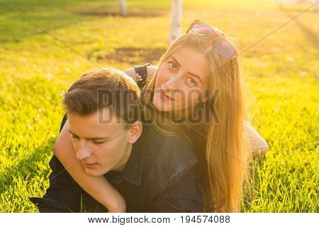 Beautiful young happy couple having fun in the grass