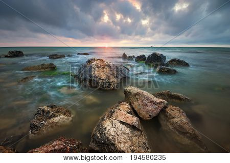 Beautiful seascape. Stones on sea shore. Nature composition.