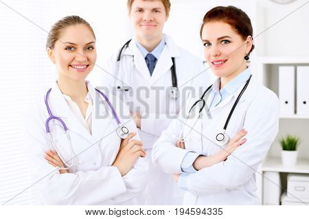 Happy doctor woman with medical staff at the hospital