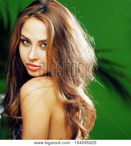 young cute blonde woman on green palm background smiling happy, lifestyle peole concept close up