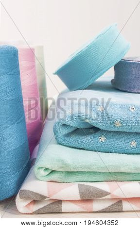 Sewing kit. Thread blue, pink, beige, cloth fabric,rolls ribana grey and menthol