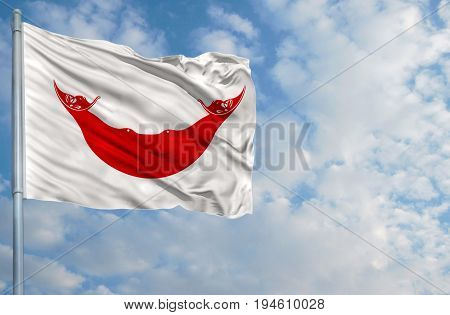 National flag of Easter Island Rapa Nui on a flagpole in front of blue sky.