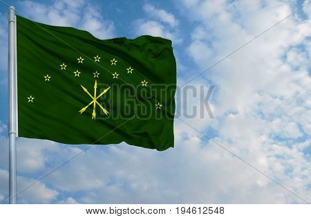 National flag of on a flagpole in front of blue sky.