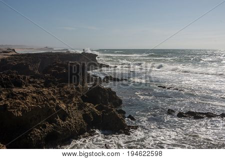 Waves  Breaking Of Cliffs Near Oualidia Lagoon In Same Name Village In Atlantic Ocean Coast, Morocco