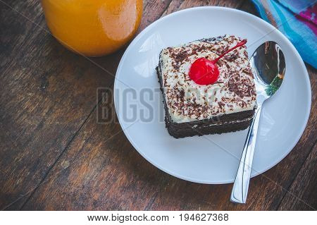 tasty chocolate cherry cake dessert on wood table and copy space