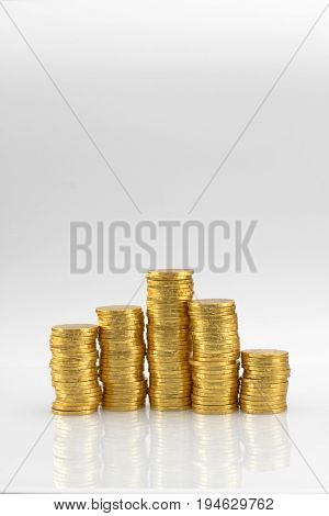 5 stacks of golden coins with white background