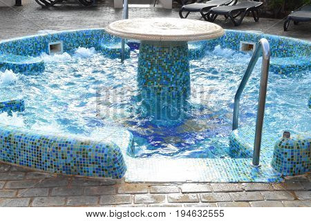 Mosaic  hottub whirlpool pool in summertime