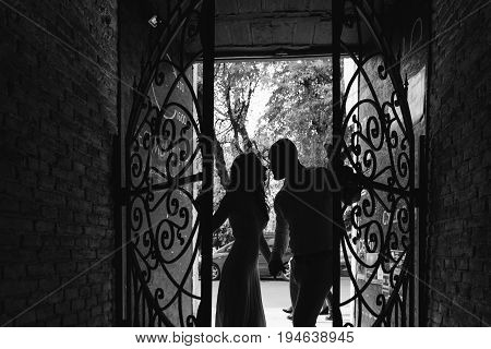 Spring day. Young beautiful bride and groom walking along the street in the city. Wedding