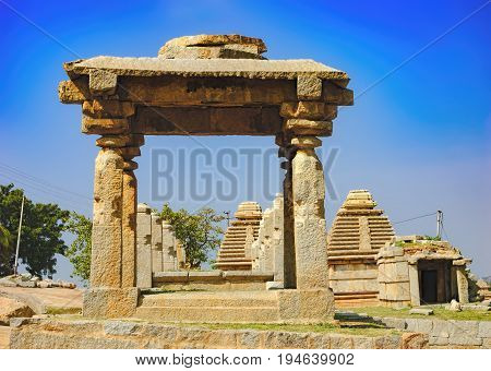 View of ancient ruins on Hemakuta hill in Hampi, Karnataka, India. Landscape with unique mountain formation with amazing stones tropical nature and temple. UNESCO World Heritage Site