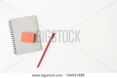 notebook paper red sticky note paper clip and pen on white background flat lay