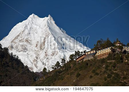 Himalayan buddhist monastery in front of Manaslu Peak (8156 m) - the eighth highest mountain in the world.