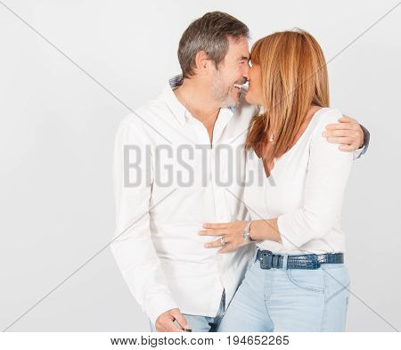 Mature couple laughing in photo studio while posing for session