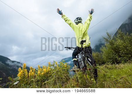 Mountain bike cyclist near fjord, summer Norway