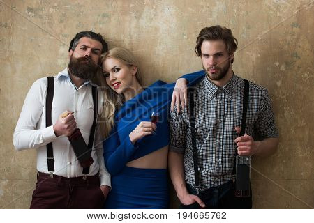 Girl Holding Glass Of Liqueur And Men With Wine Bottles