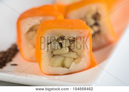 Dessert Maki Sushi - Roll With Various Fruit In Rice Pudding And Coconut Flakes