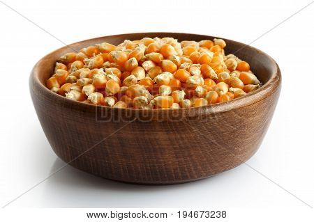 Unpopped Popcorn In Dark Wooden Bowl Isolated On White.