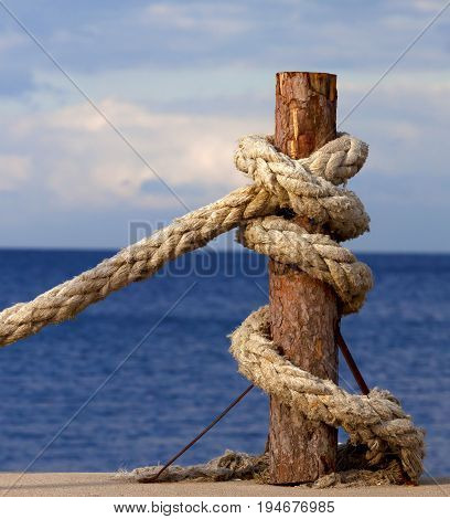 Rope On Seafront And Cloudy Sky In Autumn Evening