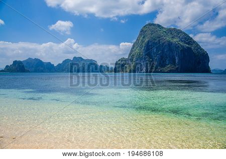 Huge Rock of Pinagbuyutan Island in blue ocean. Landscape of El Nido. Palawan island. Philippines.
