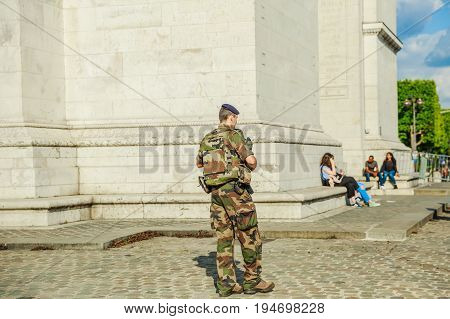 PARIS, FRANCE - JULY 2, 2017: soldier on duty at Place Charles de Gaulle, Arc de Triomphe.