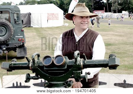 Sandhurst, Uk - 18Th June 2017: Vintage Toned Shot Of An Enthusiast Demonstrating A Ww2 Rangefinder