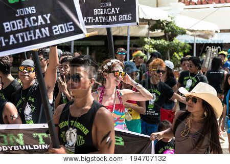 BORACAY, WESTERN VISAYAS, PHILIPPINES - JANUARY 11, 2015: Smile of white woman among many filipinos at Ati-Atihan Festival at White Beach.