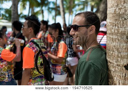 BORACAY, WESTERN VISAYAS, PHILIPPINES - JANUARY 11, 2015: Foreigner smile while watch the holiday of Ati-Atihan Festival at White Beach.