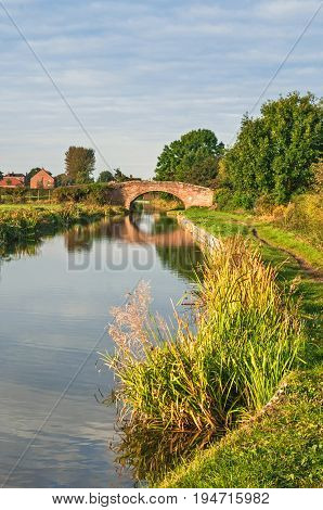 Peaceful Canal and Tow Path with Small Brick Bridge