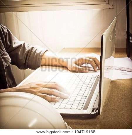 Silhouette hand business man working with smart phone and computer to work wirelessly. Press OK Trading smartphone and computer. Concept boundless business and technology flare light.selected focus.