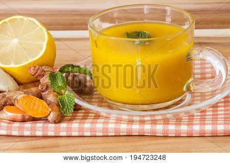 a cup of Turmeric Tea with lemon and ginger Benefits for reduce Inflammation Liver Detox and Cleanser healthy herb drink concept