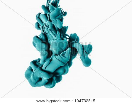 Ink swirl in a water, isolated on white background. The green paint in the water. Soft dissemination a droplets of colored ink in water close-up. Explosion of color splashes acrylic ink.