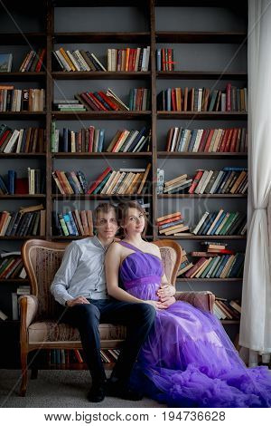 pregnant woman and man posing together in Studio, happy waiting