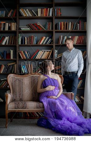 pregnant woman and man posing together in Studio, happy waiting