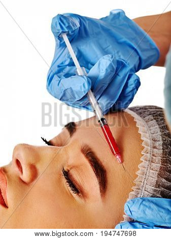 Filler injection for female forehead face. Plastic aesthetic facial surgery by doctor in beauty clinic. Beauty woman giving njections. Expensive procedure wrinkle removal.