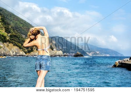 Tourist Girl in Monterosso al Mare Italian riviera. Sea and mountain view. Cinqueterre Liguria beauty