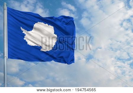 flag of Antarctic on a flagpole in front of blue sky.