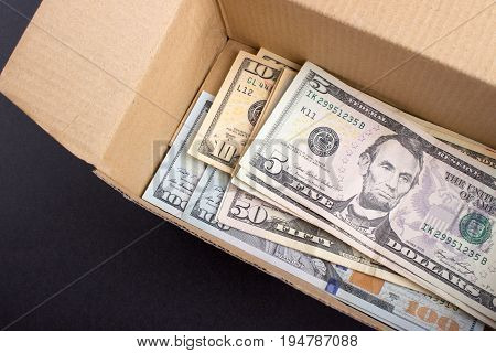A pile of dollar bills lying in a box.