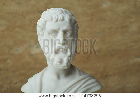 Statue of Sophocles, ancient Greek poet on brown background.