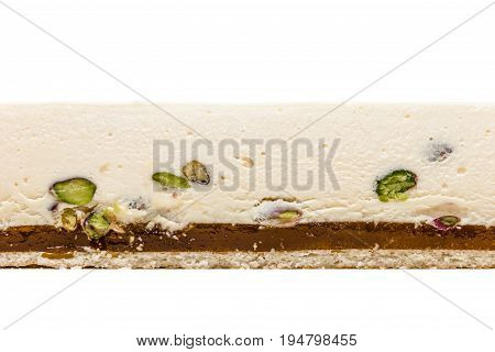 White chocolate mousse with passion fruit cake texture on white background. With pistachios passion fruit marmalade biscuit