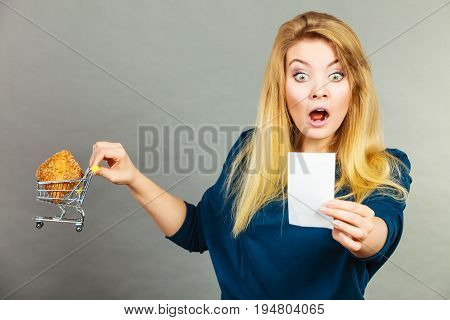 Shocked Woman Holding Shopping Basket With Bread
