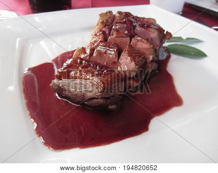 Duck breast on Sangiovese red wine sauce . Duck chest italian recipe
