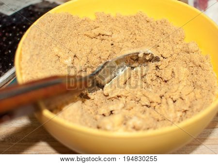 Biscuit Crumbs And Butter In Yellow Bowl Close Up